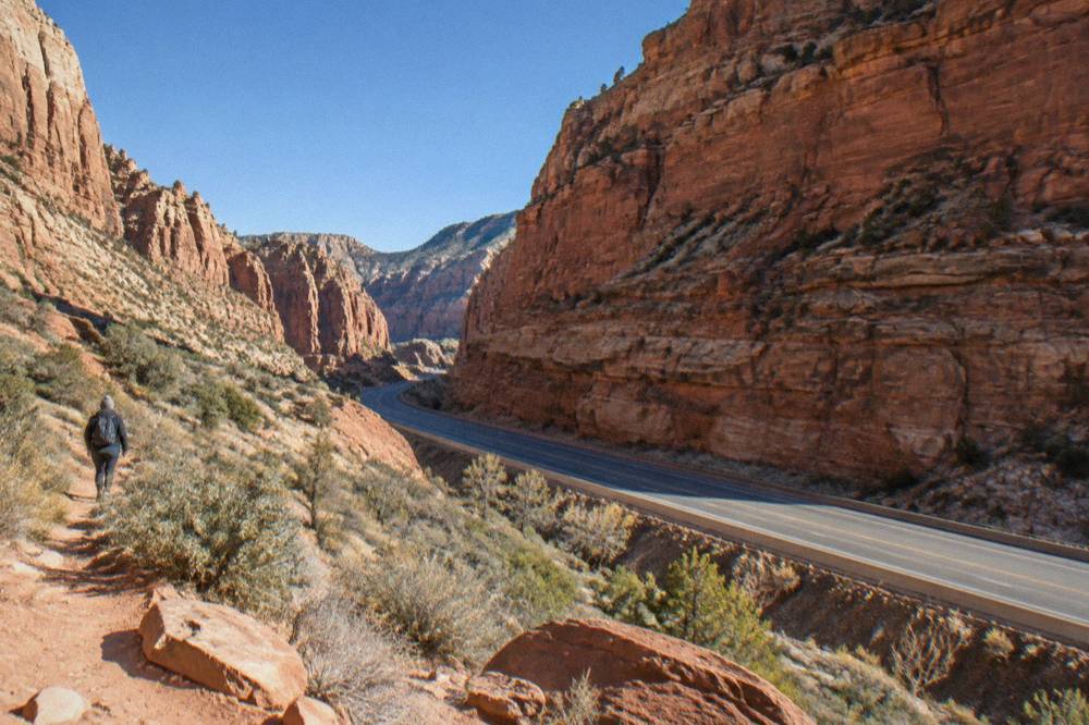 Red rock cliffs and open rangeland along a rural Utah highway