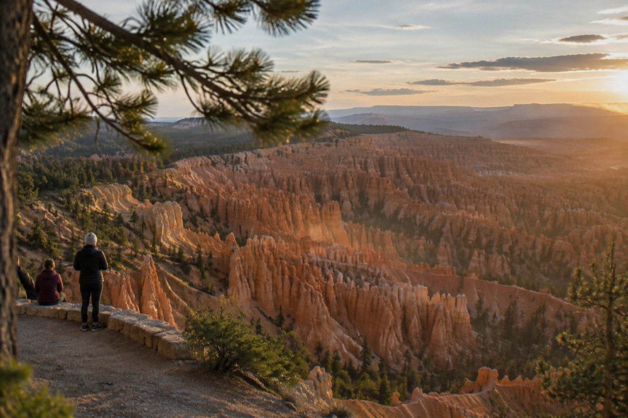 Sunlit hoodoos of the Bryce Amphitheater below a partly cloudy sky at Bryce Canyon