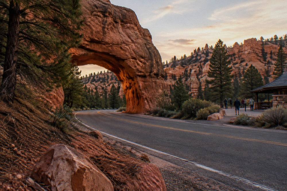 Highway curving through red rock formations near the entrance to Red Canyon