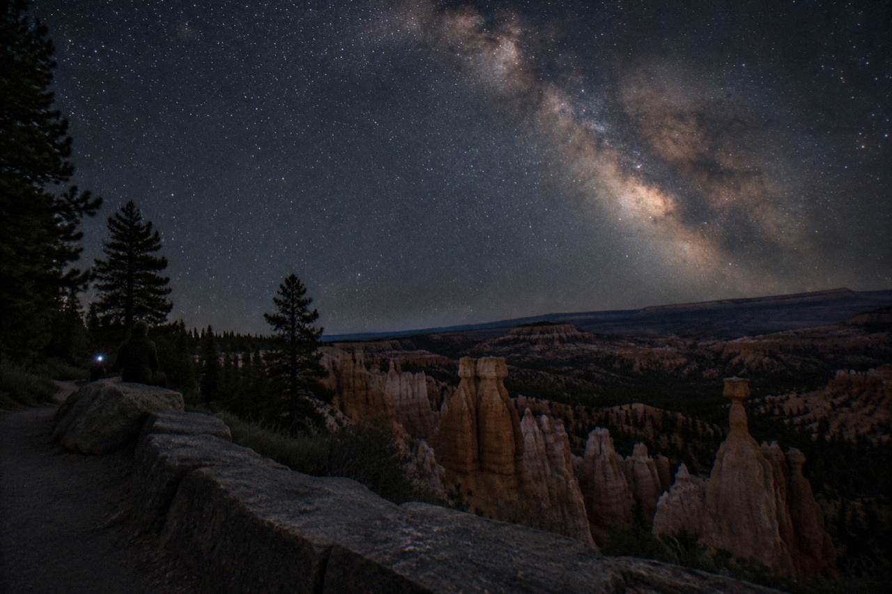 Milky Way over hoodoo silhouettes on a high desert plateau under a star-filled sky