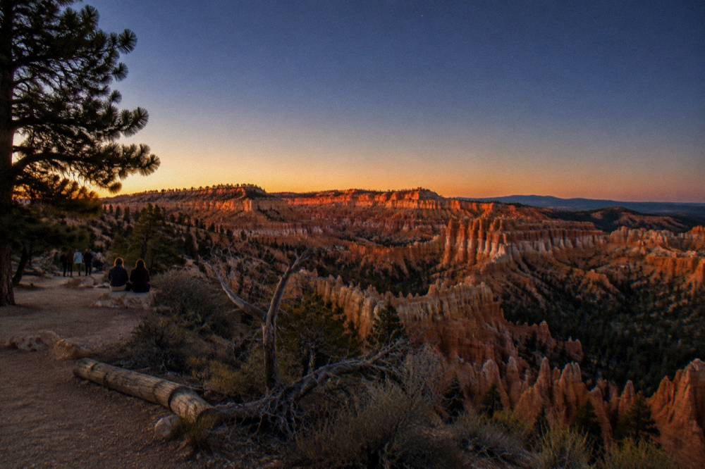 Sunset light on red rock formations under a wide open sky