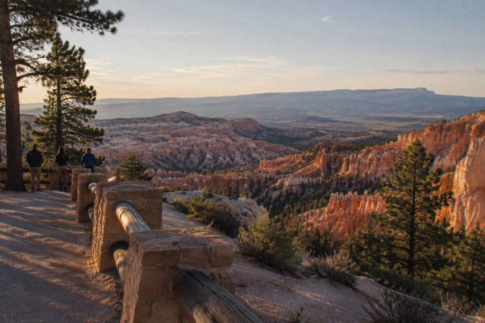 Quiet overlook at Bryce Canyon with distant plateau horizon in clear evening light