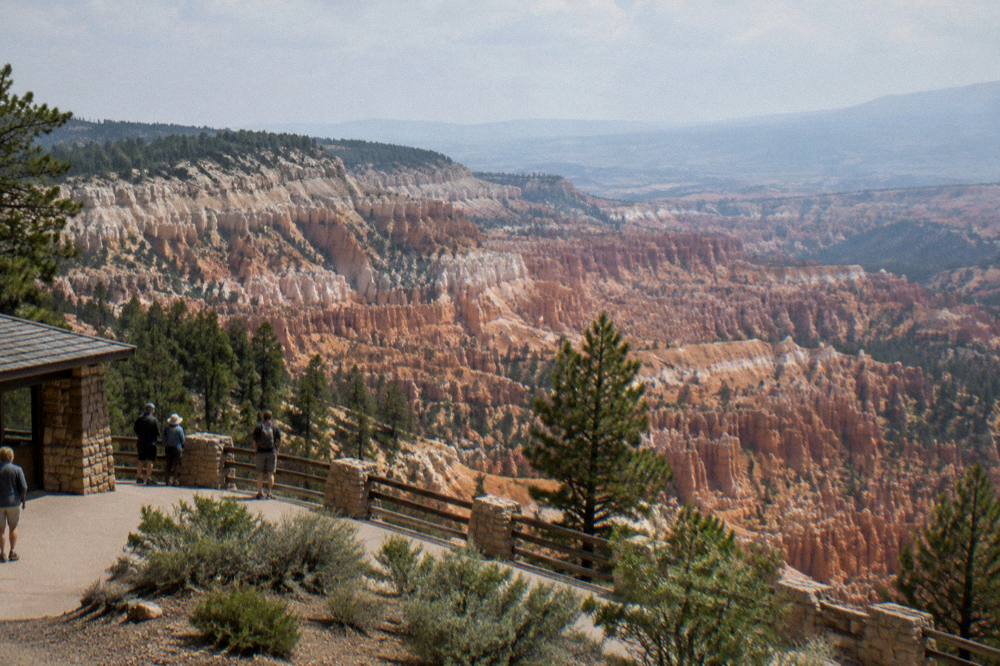 Wide aerial panorama of layered orange and white rock terraces at Bryce Canyon