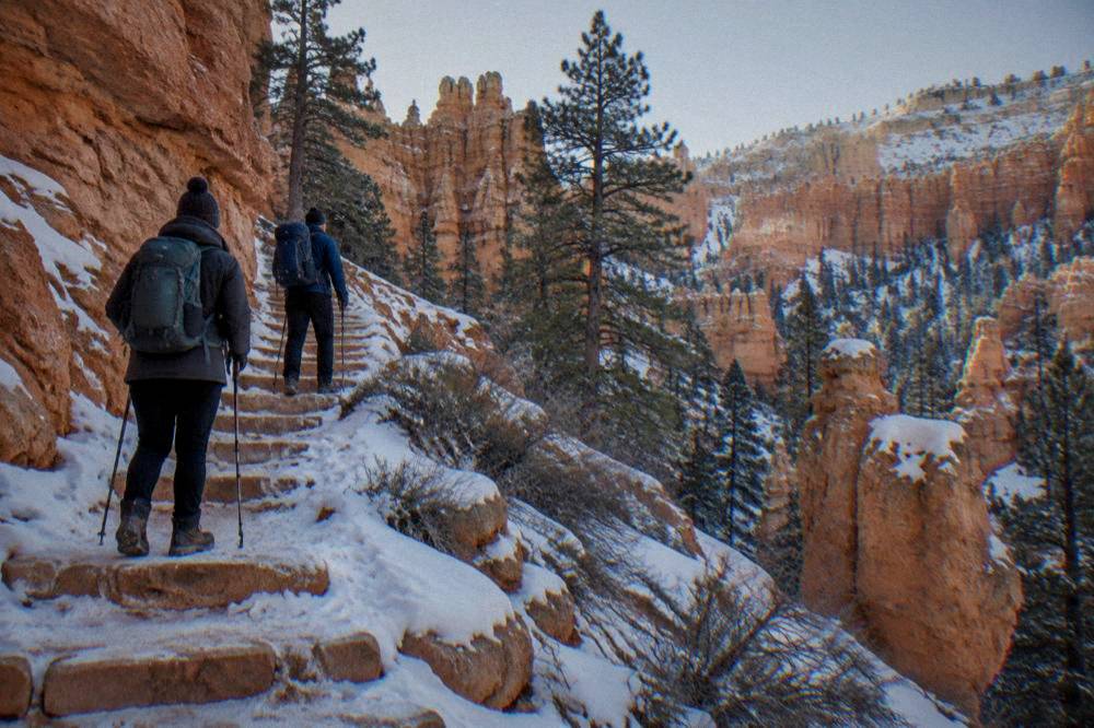 Hikers resting on a switchback trail climbing back toward the rim at Bryce Canyon