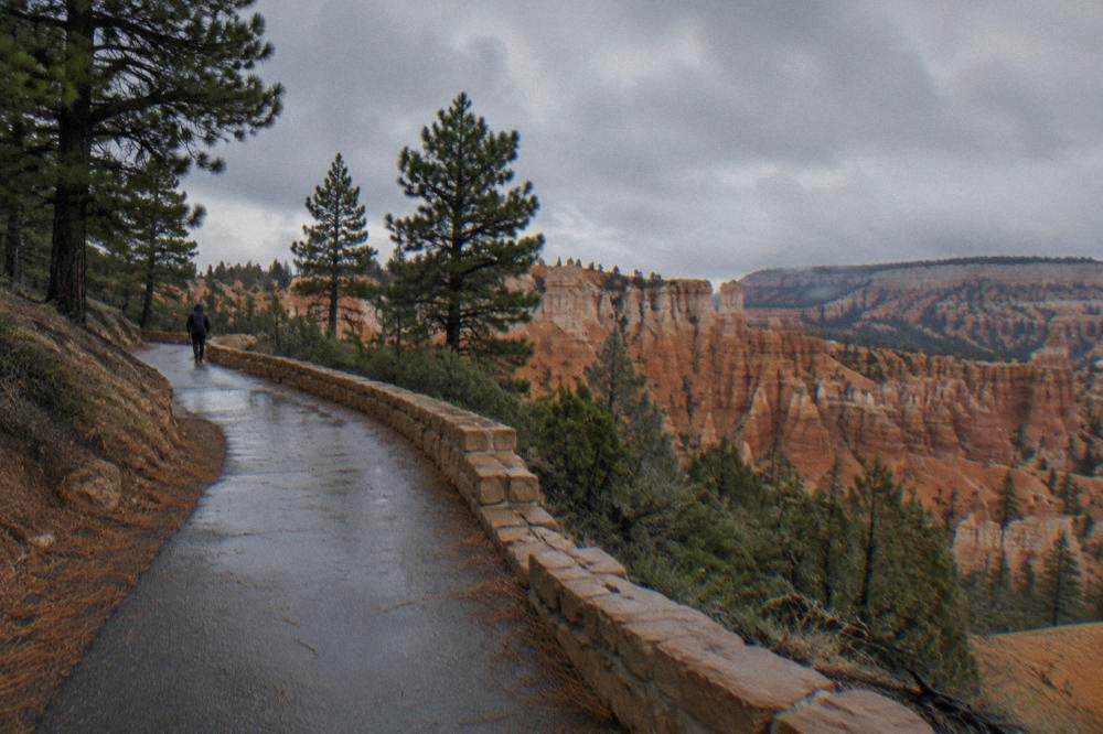 Paved rim path curving along the canyon edge between viewpoints