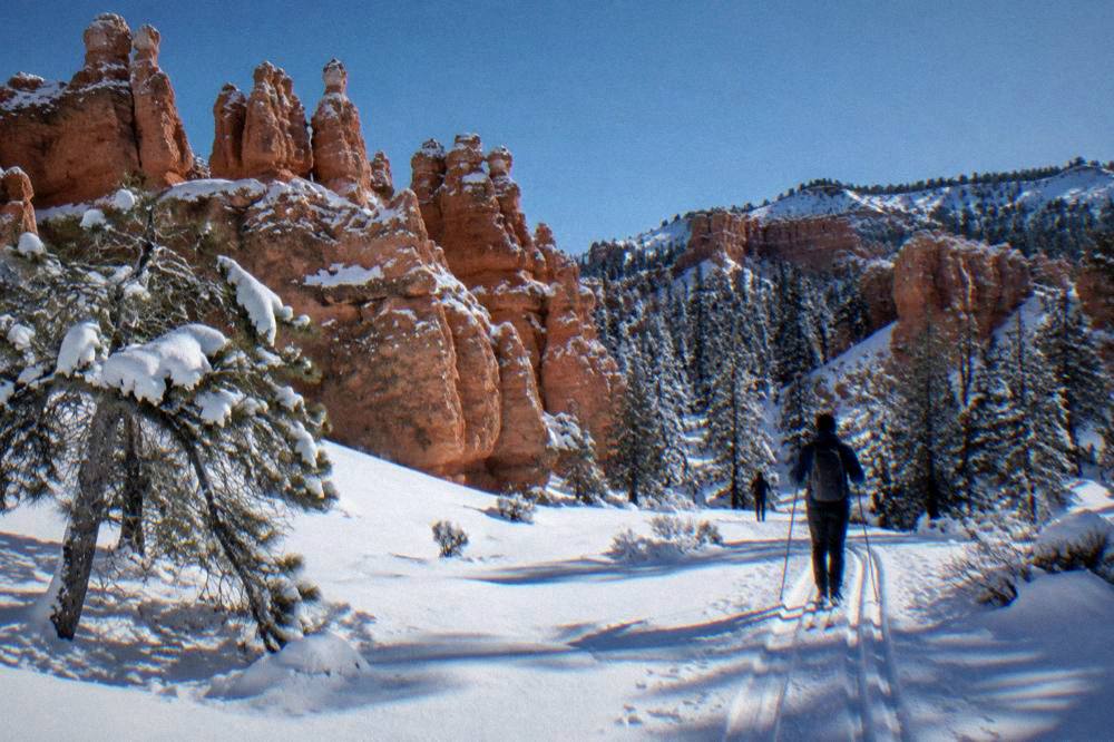 Snow-dusted red hoodoos under a clear winter sky