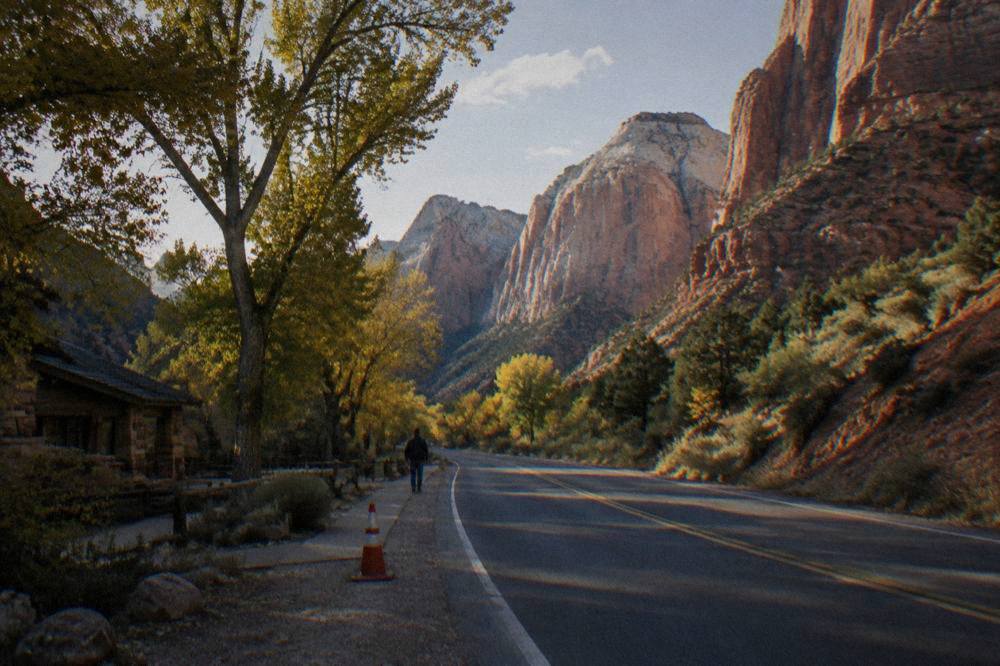 Highway winding through red rock cliffs toward Zion Canyon